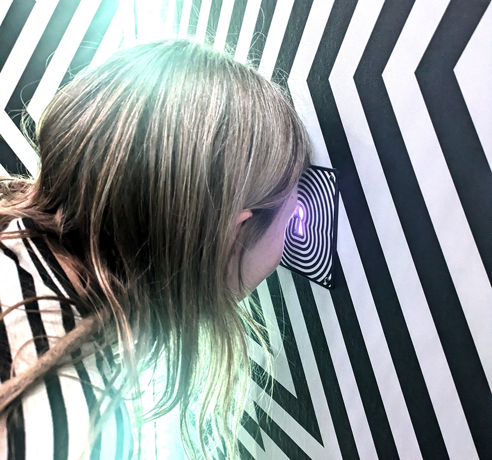 Audience looking through a keyhole portal at Wake The Tiger